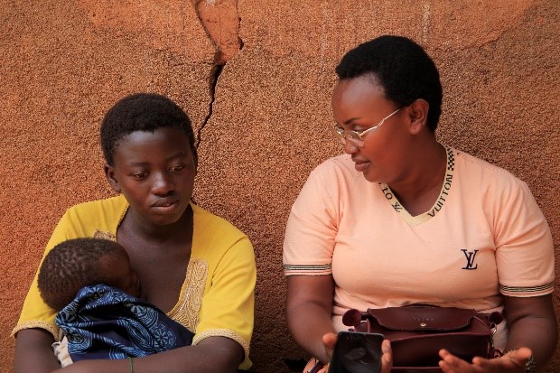 Perpetue (left) meets with mentor mother Belyse (right) at SWAA Clinic