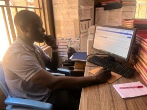 A man sits in front of a computer